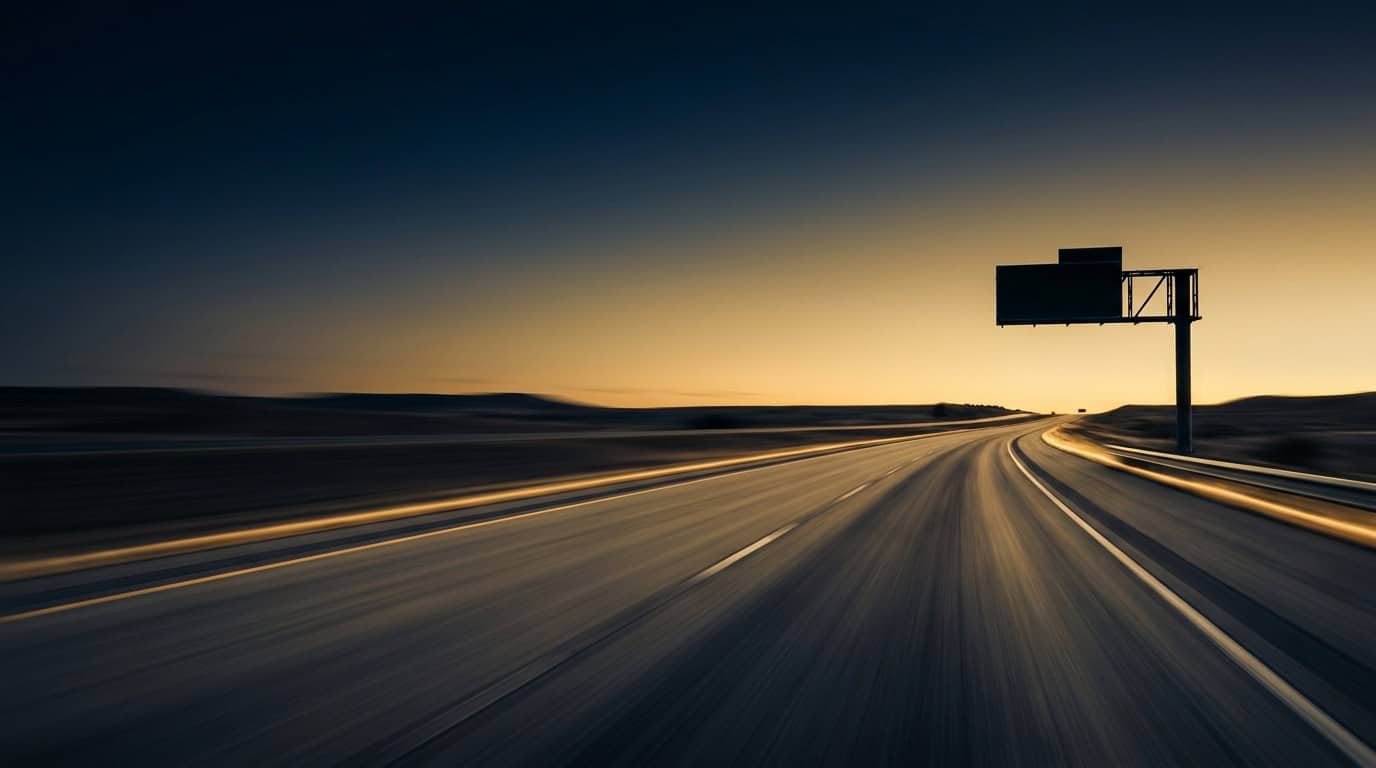 Open Central Texas toll highway at dusk with motion blur and a roadside sign silhouette